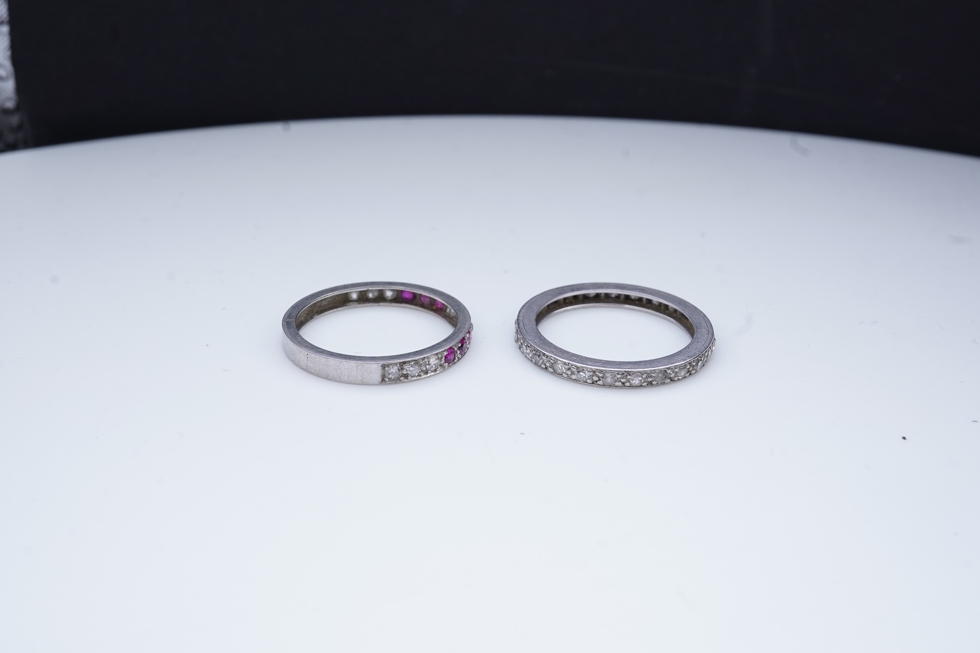 A diamond eternity ring and a ruby and diamond half eternity ring, mid 20th century
